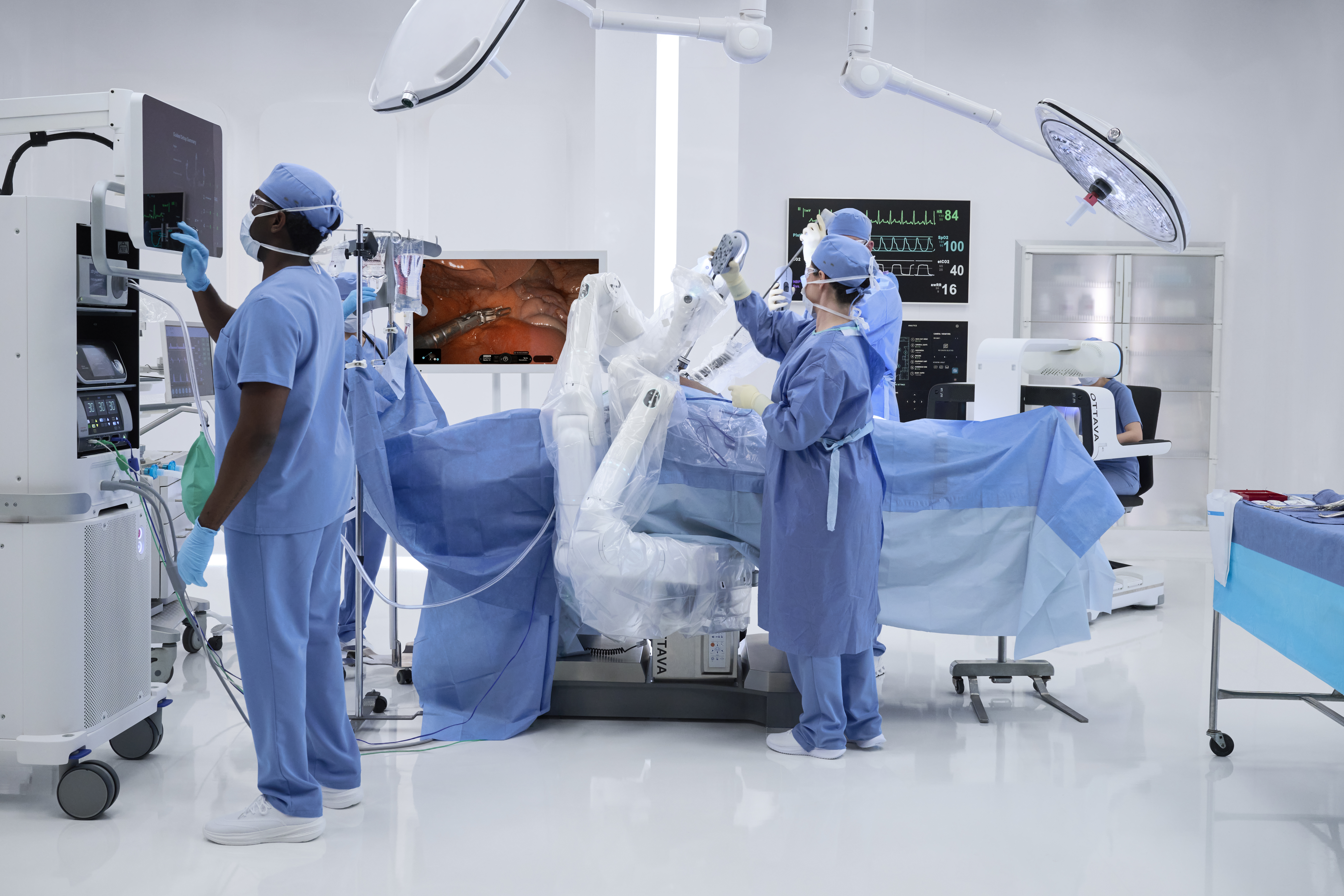 OR staff working with the OTTAVA table-integrated robotic surgical system
